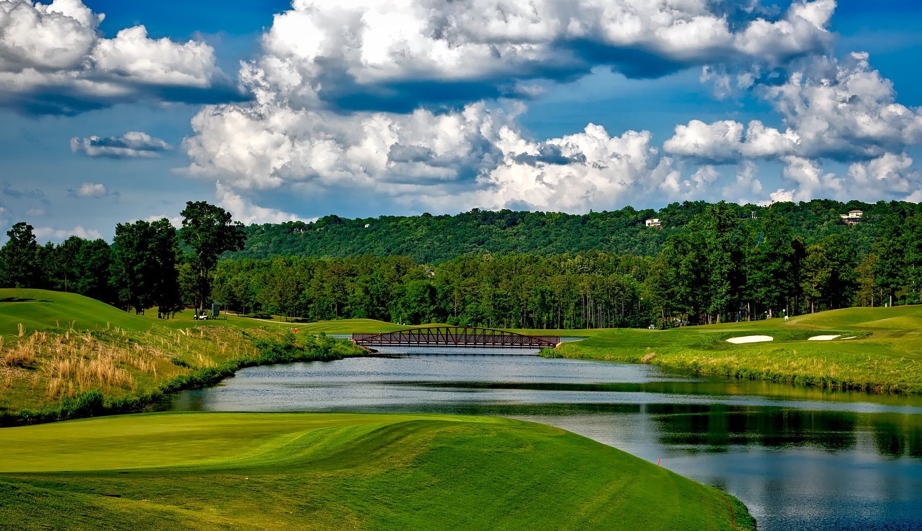 A landscaped golf course with a lake and open green space