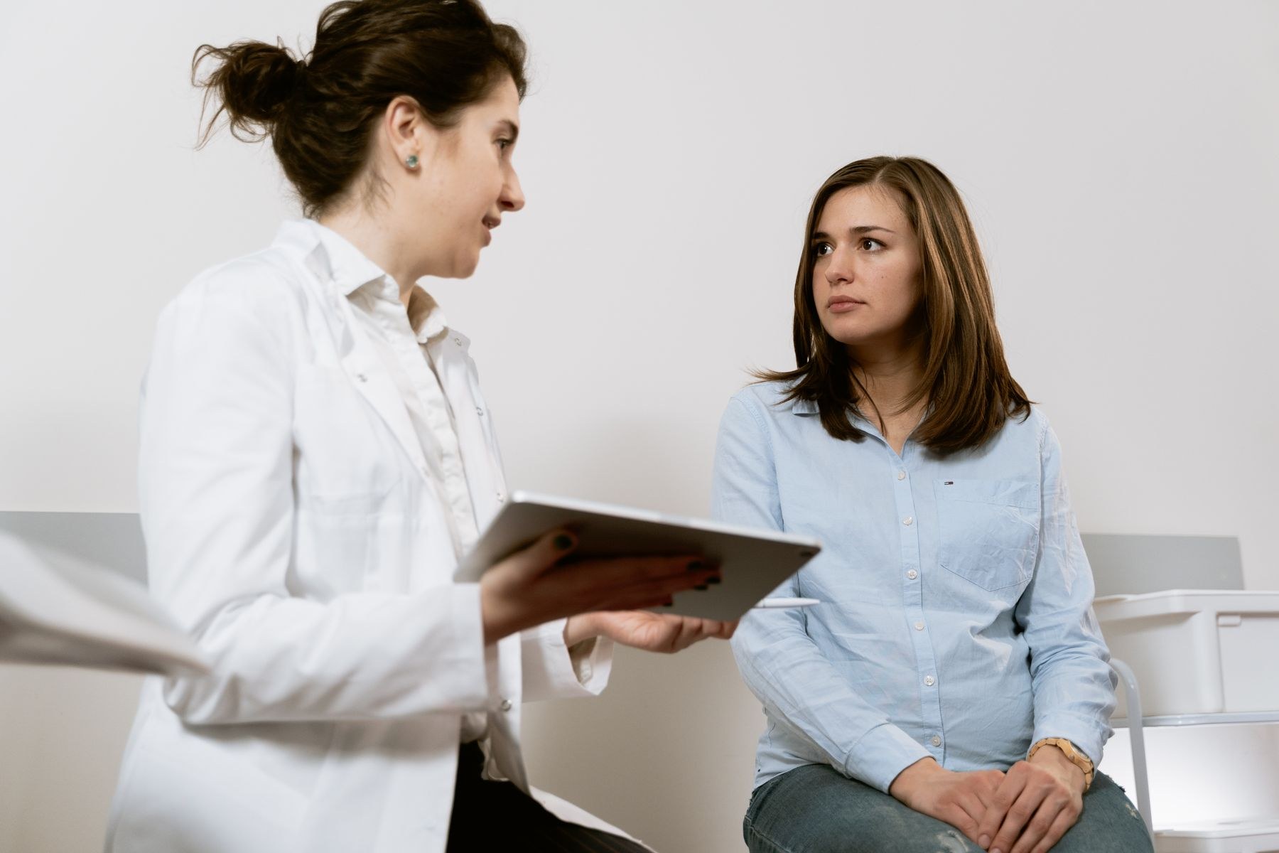 A physician discussing care with a patient face to face